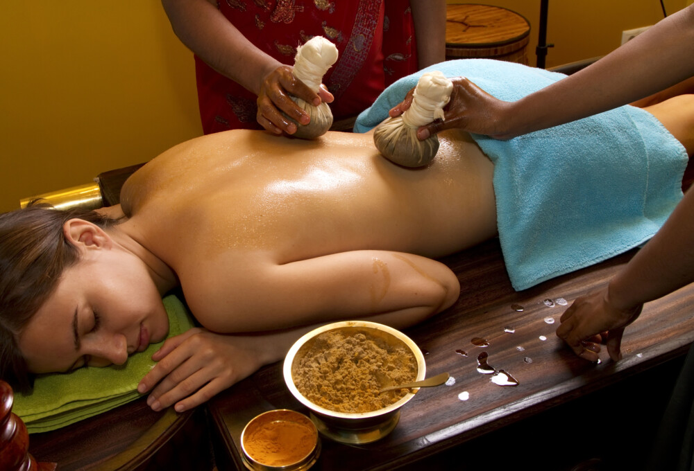 Ayurvedic potli massage on lower back for sciatica and joint pain relief